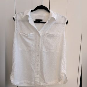 Sleeveless button down seer-sucker shirt. Oversized, not be too sheer.